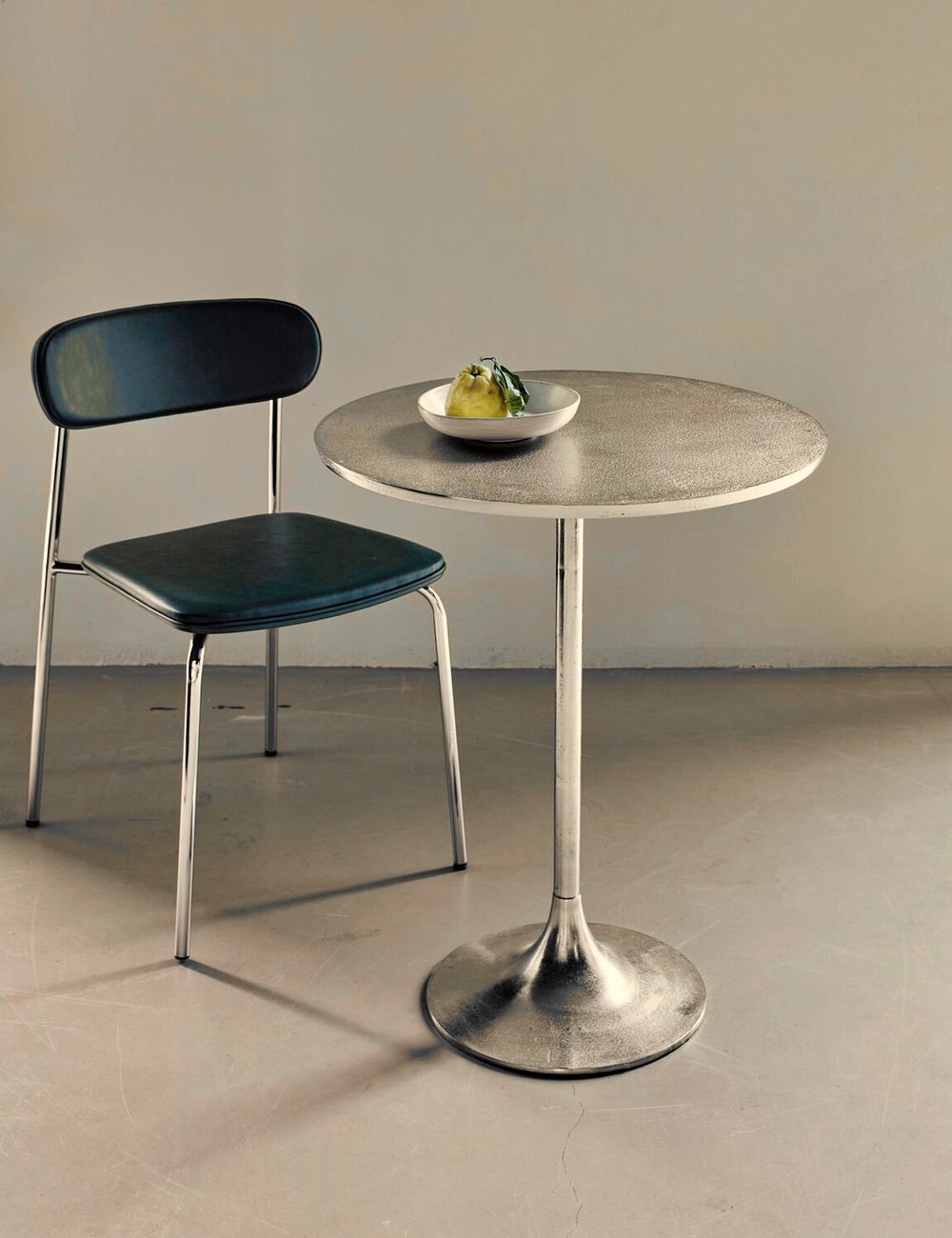 Pan Silver Finish Cafe Table in a room setting